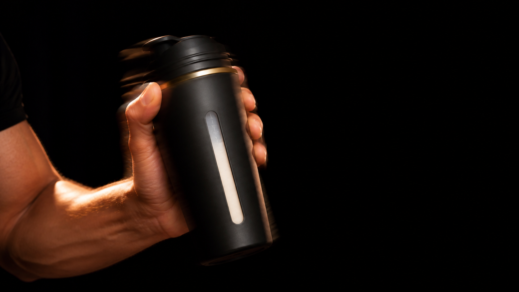 Athletic hand shaking a closed black SOYPRO shaker